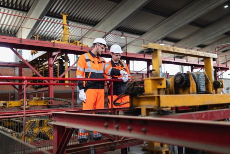 Two factory workers overlooking process