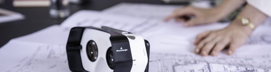 Virtual headset and blueprints at conference table