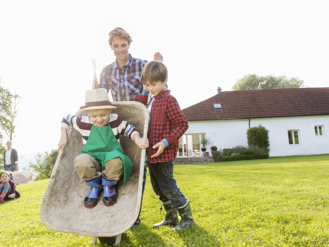 Family fun in the garden with single family house in the background