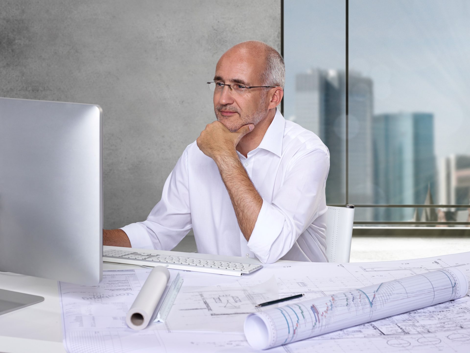 architect man sitting at table computer