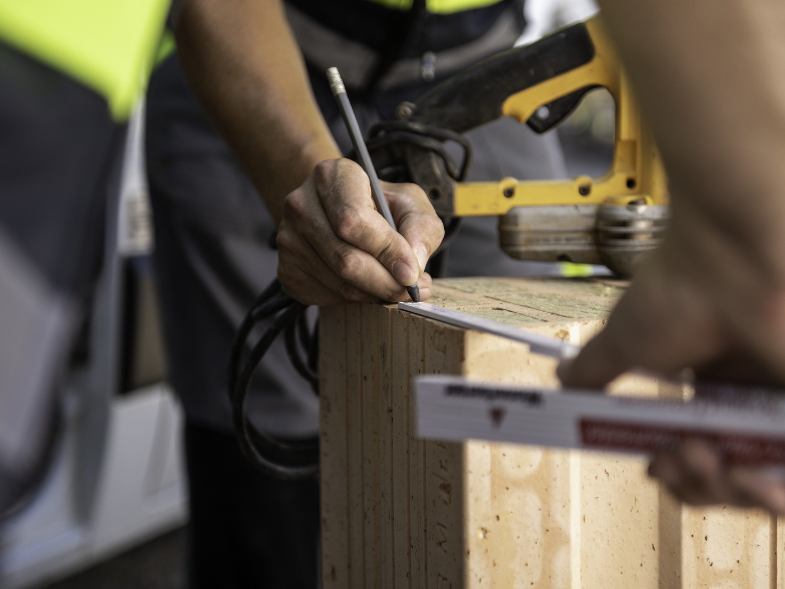 Field service employee at construction site supporting building professional in front of van